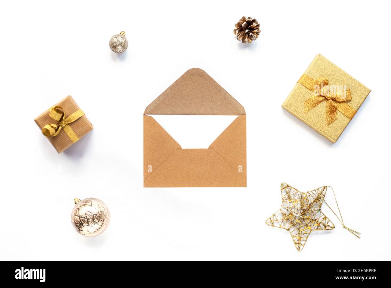 Envelope on white background with Christmas gifts and decorations. Top ...