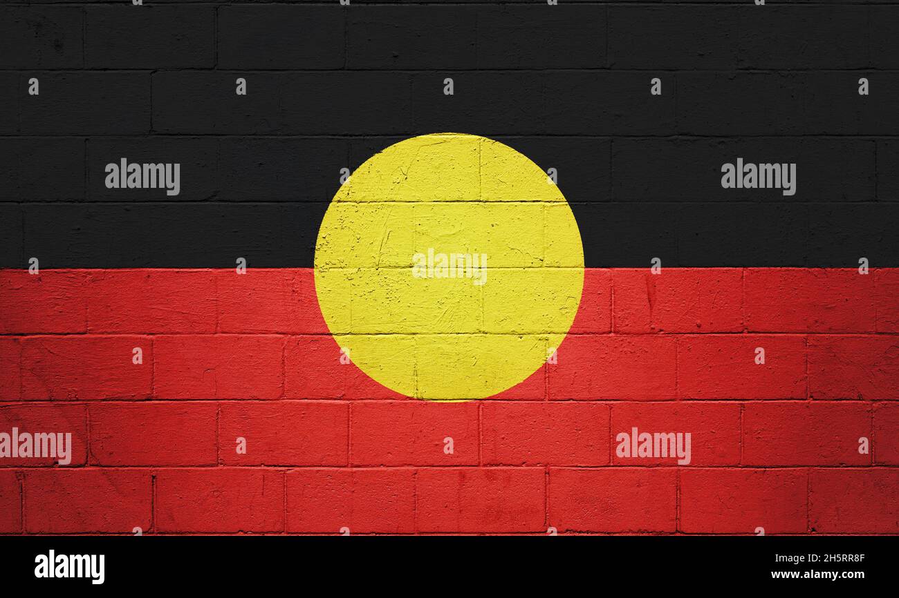 Australian Aboriginal Flag flag painted on a brick wall. Stock Photo