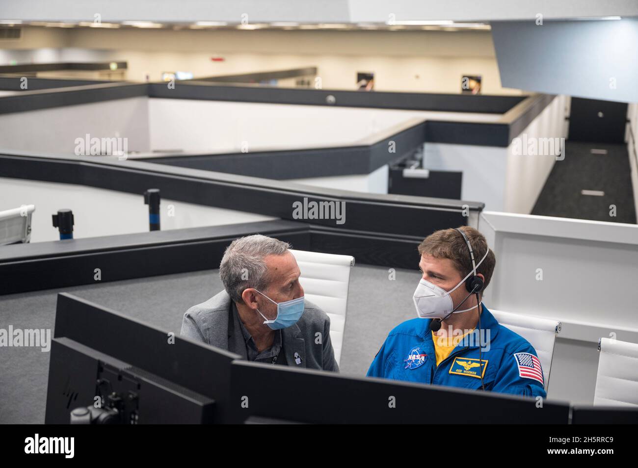 Lee Rosen, vice president of Mission and Launch Operations at SpaceX, left, and Reid Wiseman, Chief of the Astronaut Office, monitor the countdown of the launch of a SpaceX Falcon 9 rocket carrying the company's Crew Dragon spacecraft on NASA's SpaceX Crew-3 mission with NASA astronauts Raja Chari, Tom Marshburn, Kayla Barron, and ESA (European Space Agency) astronaut Matthias Maurer onboard, Wednesday, Nov. 10, 2021, in firing room four of the Launch Control Center at NASA's Kennedy Space Center in Florida. NASA's SpaceX Crew-3 mission is the first crew rotation mission of the SpaceX Crew Dra Stock Photo