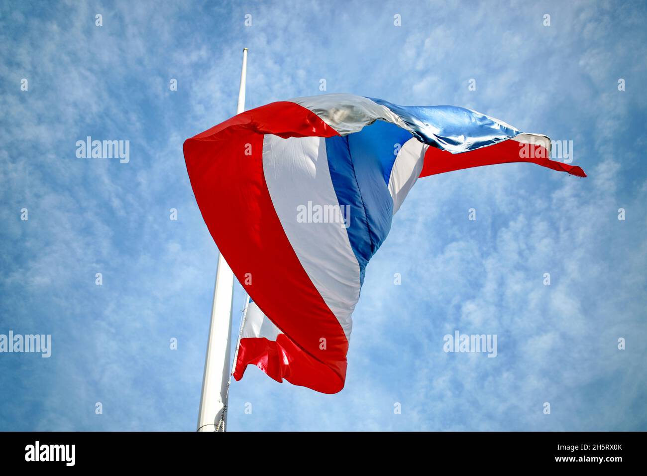 The flag of Thailand fluttering, viewed from an upward angle, seeing the sky in the background on a sunny day. Selective focus. Stock Photo