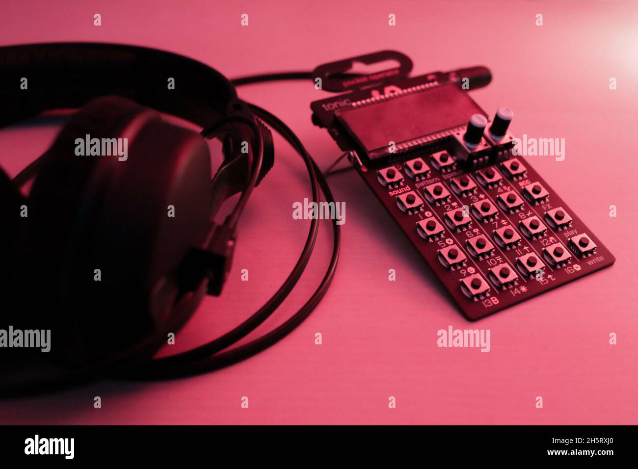 PO-32 Micro Drum machine from teenage engineering and headphones Stock Photo