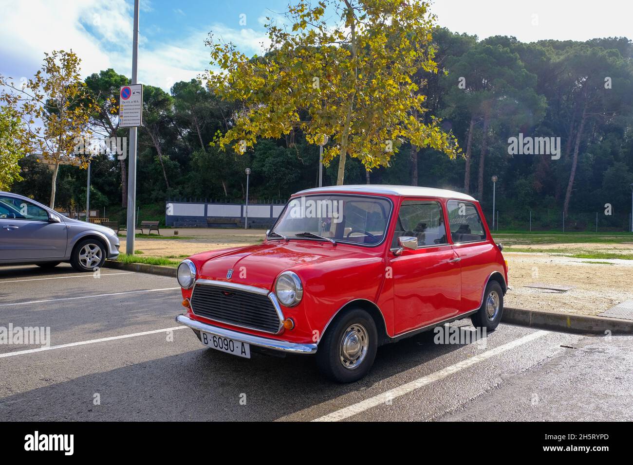 Lloret de Mar, Catalonia, Spain - 11.11.2021: bright red Mini 850 model old retro car in perfect condition parked on the city street Stock Photo