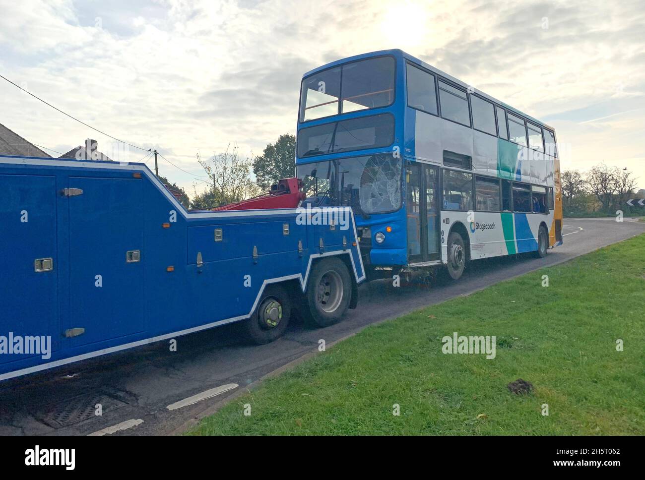 A school bus is towed away after it overturned in Meadow Lane, North Hykeham, near Lincoln. Lincolnshire Police have said no serious injuries were reported after the crash. Picture date: Thursday November 11, 2021. Stock Photo