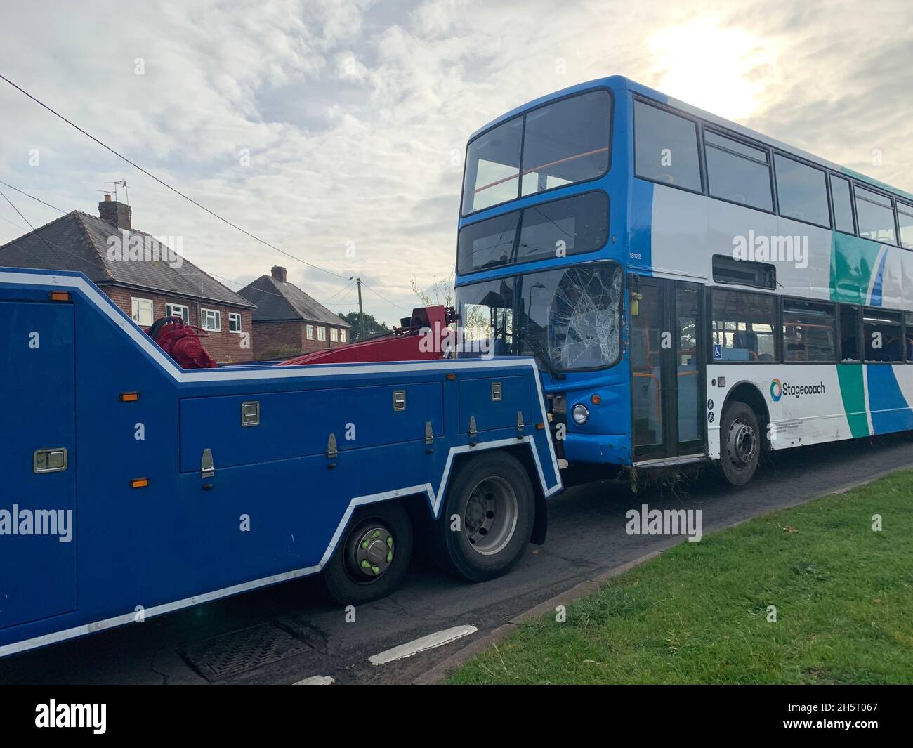 A school bus is towed away after it overturned in Meadow Lane, North Hykeham, near Lincoln. Lincolnshire Police have said no serious injuries were reported after the crash. Picture date: Thursday November 11, 2021. Stock Photo
