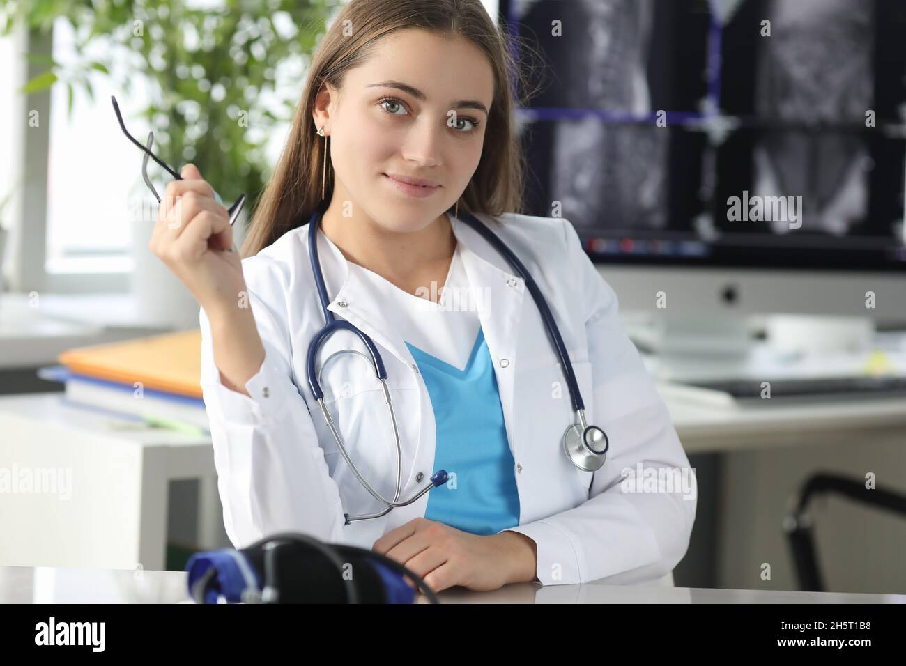 Doctor holding glasses for vision in office of clinic Stock Photo