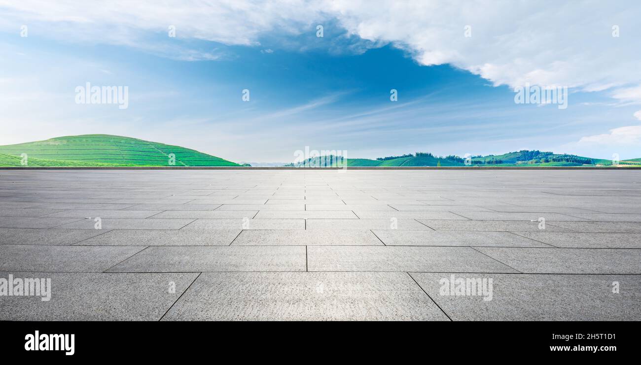 Empty square floor and green mountain background. Stock Photo