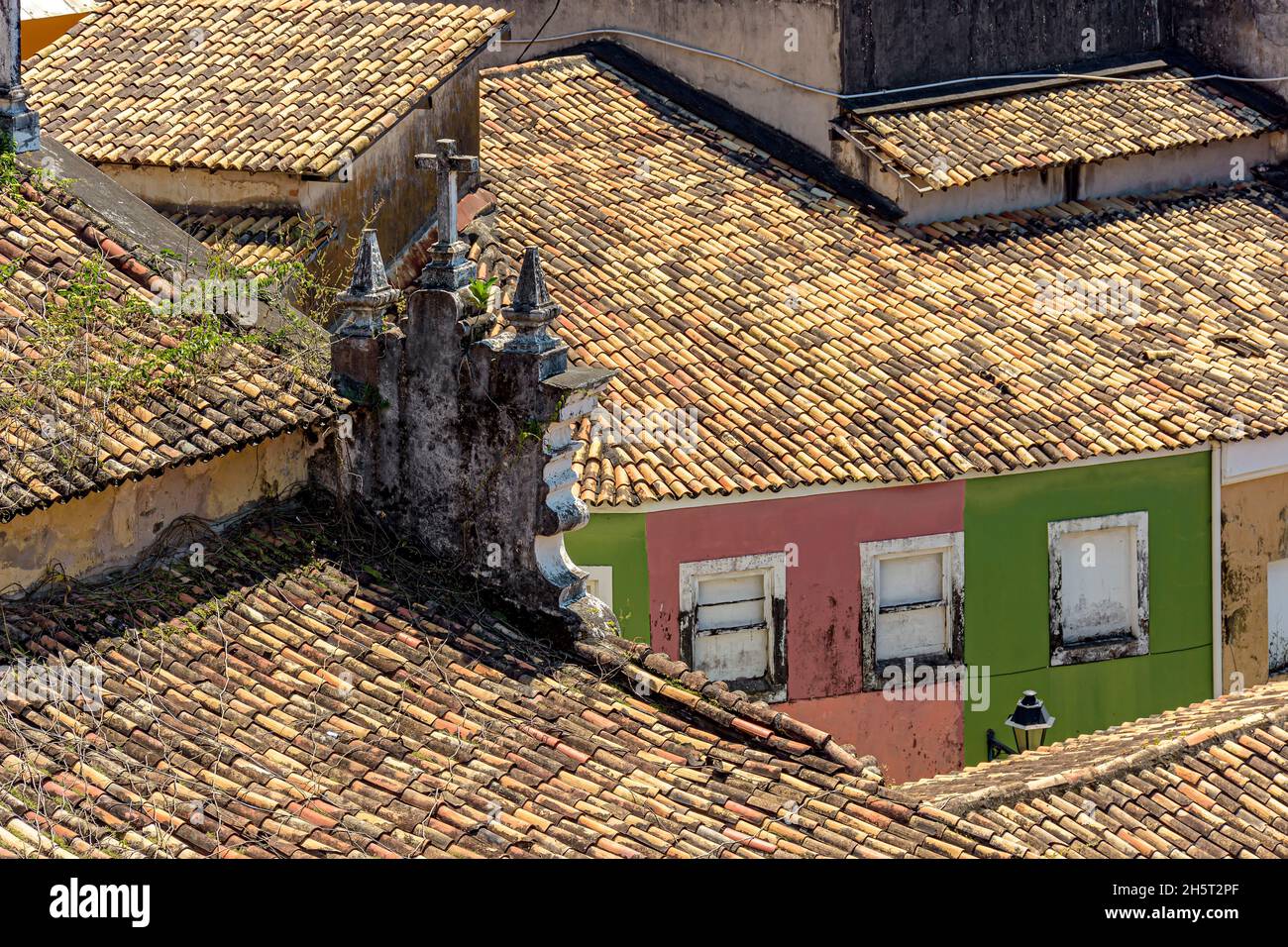 Roofs of old colonial-style houses and churches seen from above and worn by time in the Pelourinho neighborhood of Salvador, Bahia Stock Photo