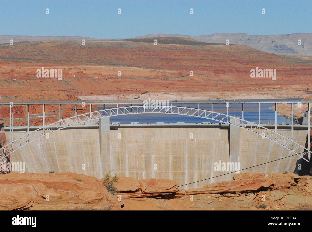 Panoramic overview of the expanse of the Glen Canyon Dam with the bridge structure, Lake Powell and surrounding red desert landscape of Page, Arizona. Stock Photo