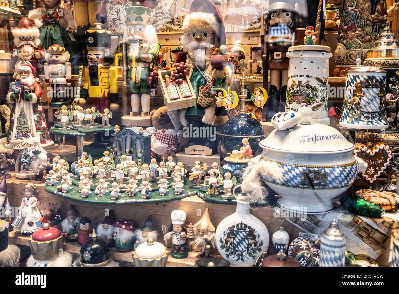 Munich, GERMANY - November 9, 2021: German christmas kitsch in a shops display window in Munich with santa claus, nutcrackers, angels and gnomes. Wind Stock Photo