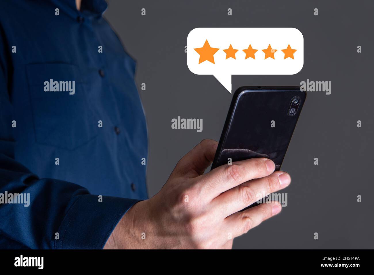 close up Man hand using smartphone with popup five star icon for feedback review satisfaction service, Customer service experience and business satisf Stock Photo