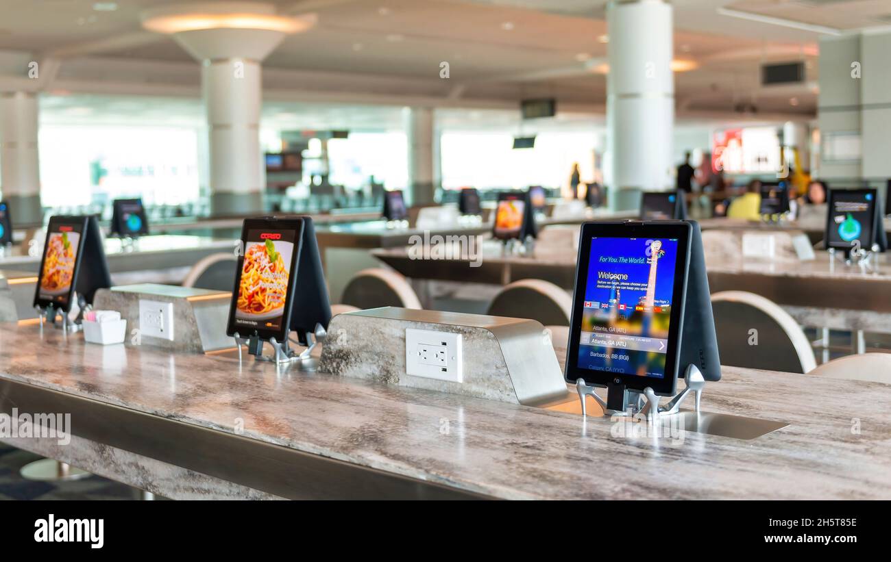 Technology use of tablets to order and pay in a Pearson Airport restaurant in Toronto, Canada. Nov. 10, 2021 Stock Photo