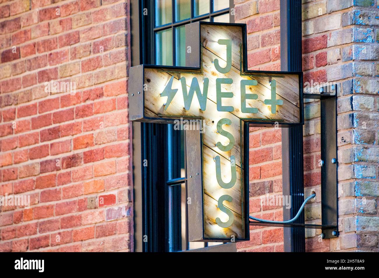 Sign of the Sweet Jesus icecream parlour in the downtown district. The place is a popular