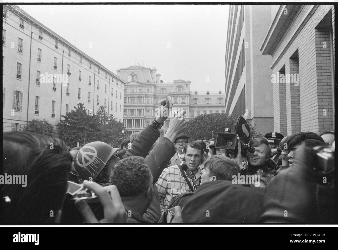 Young man wearing helmet with peace sign, burns his draft card at an anti-draft demonstration at the Selective Service System headquarters, Washington, D.C, 3/19/1970. (Photo by Marion S. Trikosko/US News & World Report Magazine Collection) Stock Photo