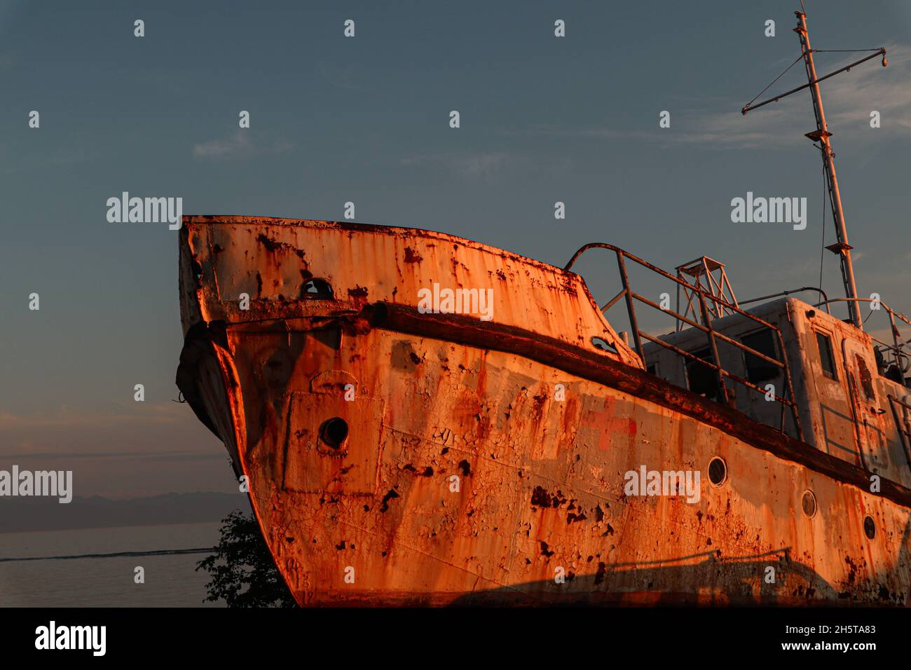 Old rusted ship on the sunset Stock Photo - Alamy