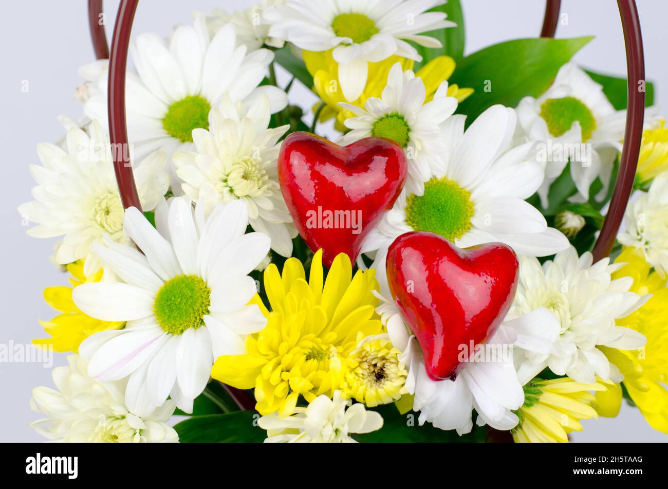 Two red hearts in a bouquet of flowers Stock Photo - Alamy
