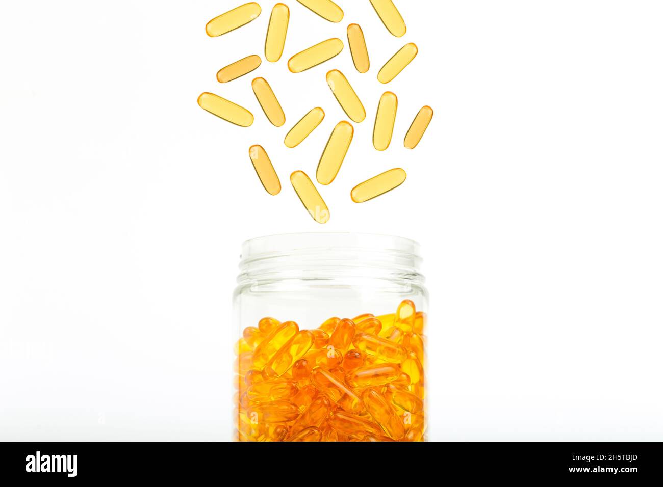 Fish oil in gelatin capsules isolate. Omega vitamins in golden colored