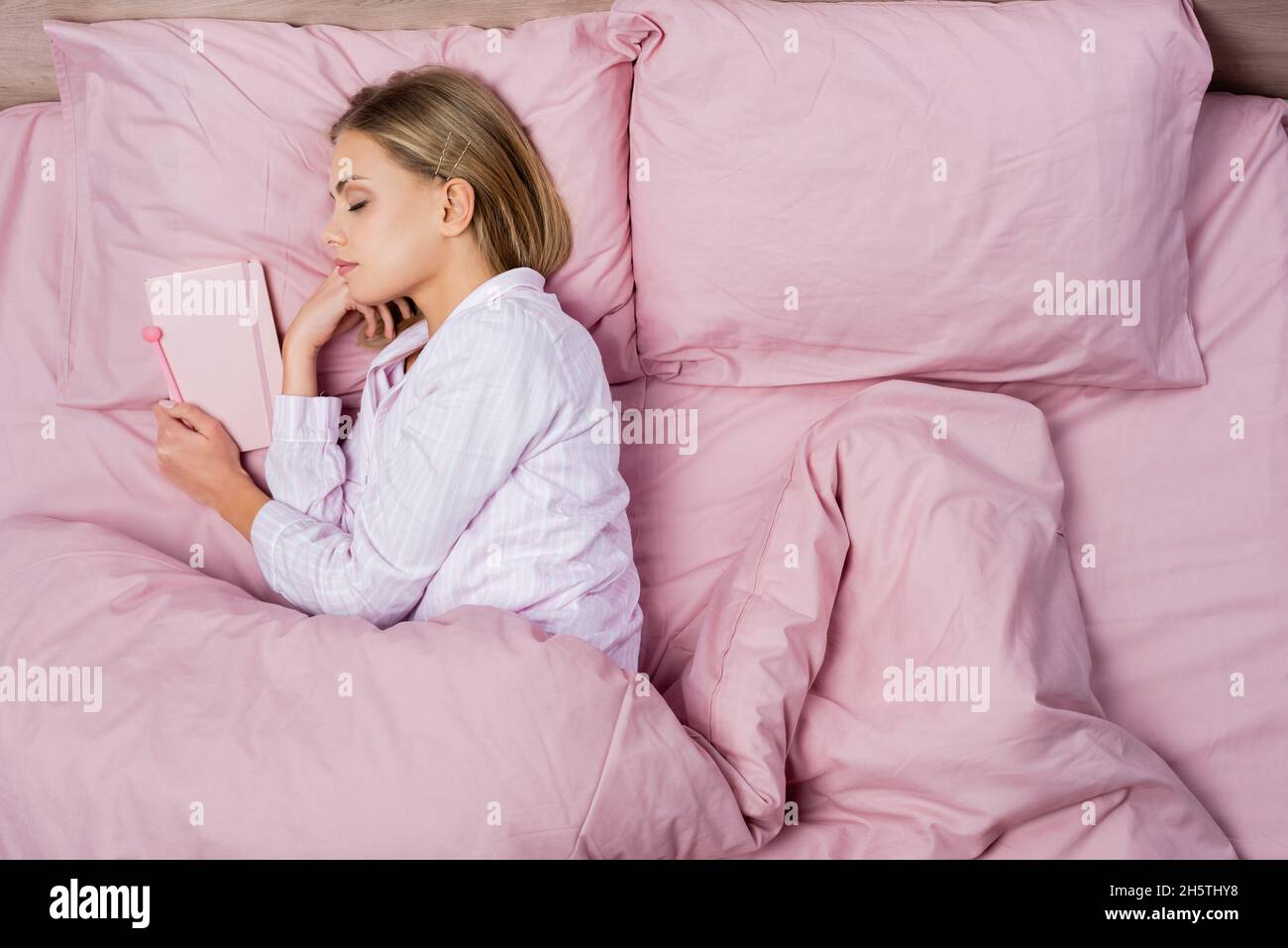 Top view of woman sleeping near notebook on bed at home Stock Photo Alamy
