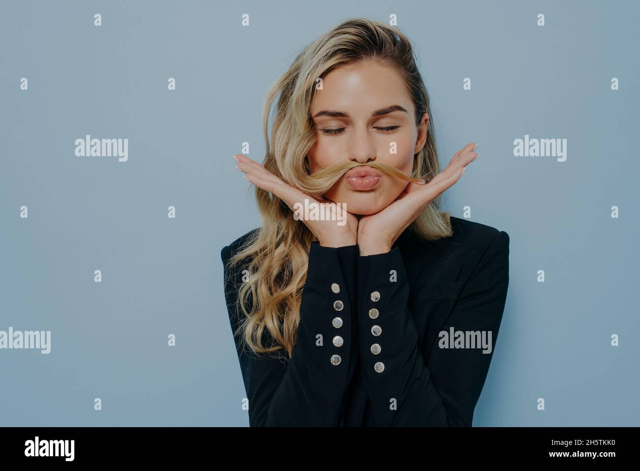 Crazy blonde woman having fun and fooling around Stock Photo
