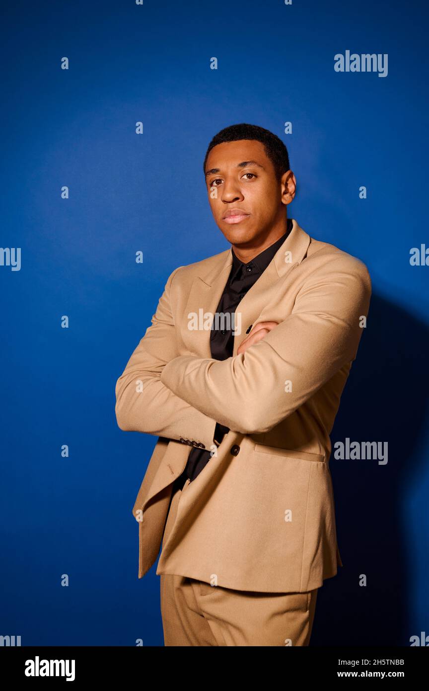 A dark-skinned good-looking young man in a suit Stock Photo