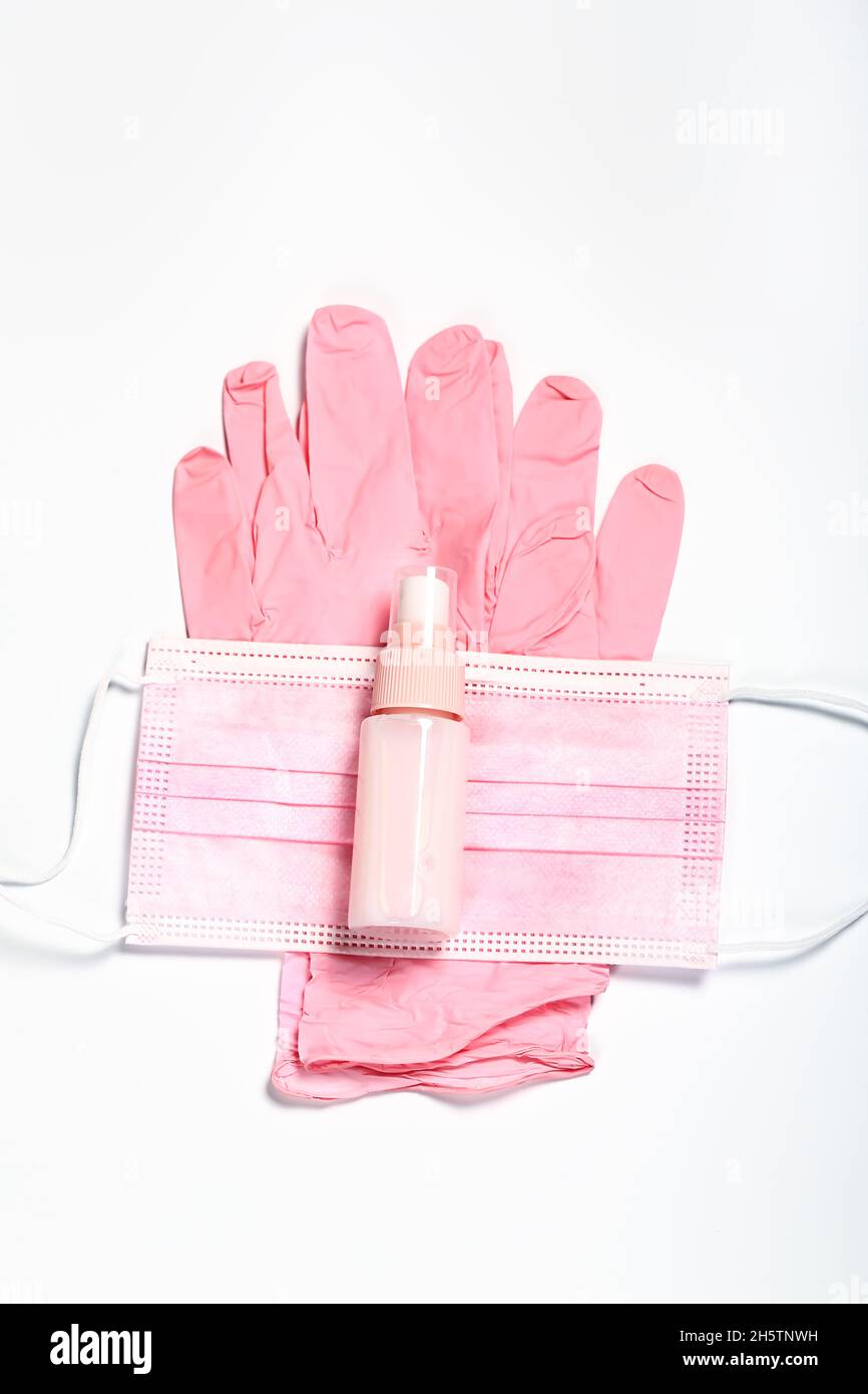 pink set of medical gloves, face mask and sanitizer. Feminine hygiene ...