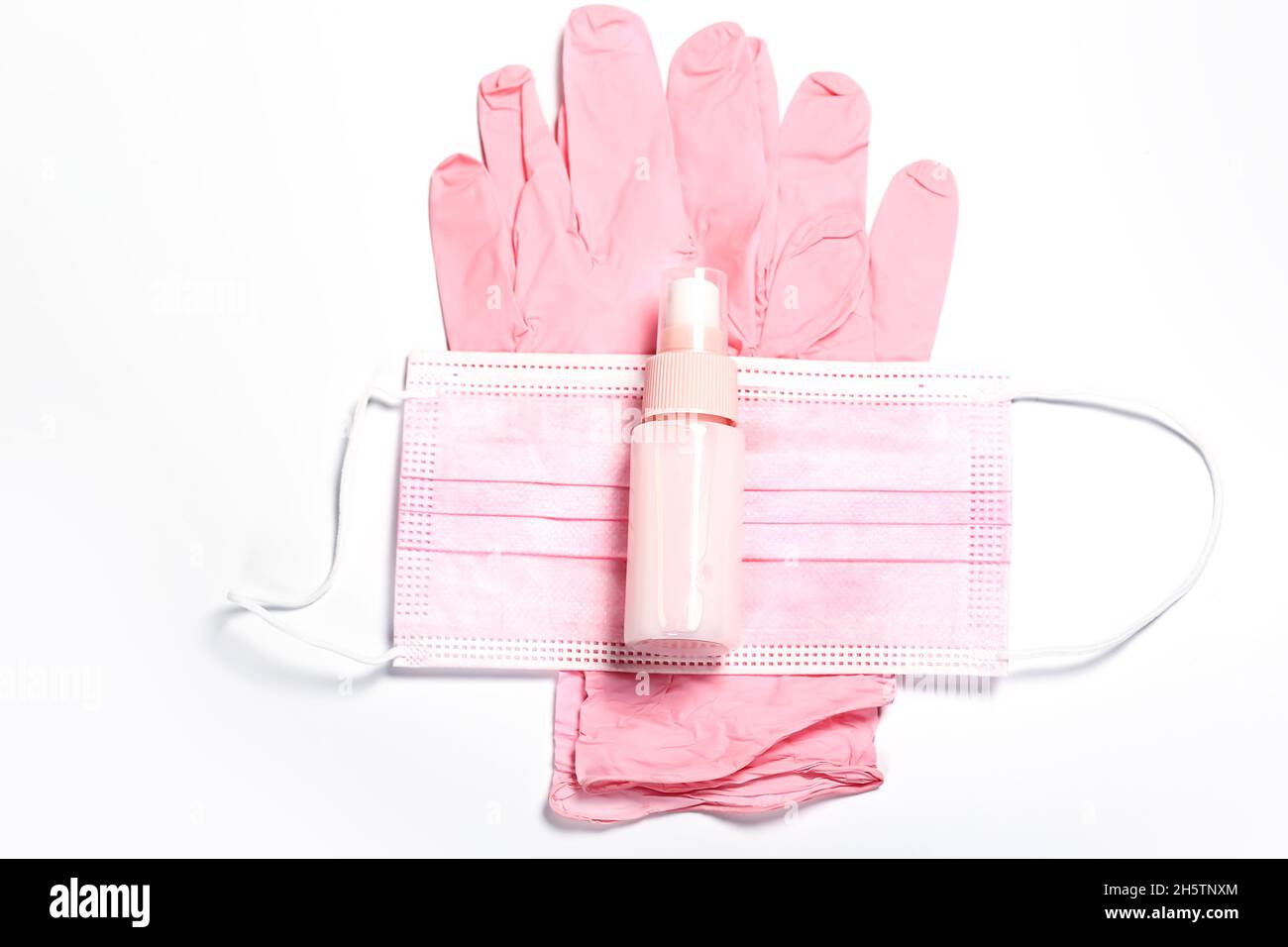 pink set of medical gloves, face mask and sanitizer. Feminine hygiene ...