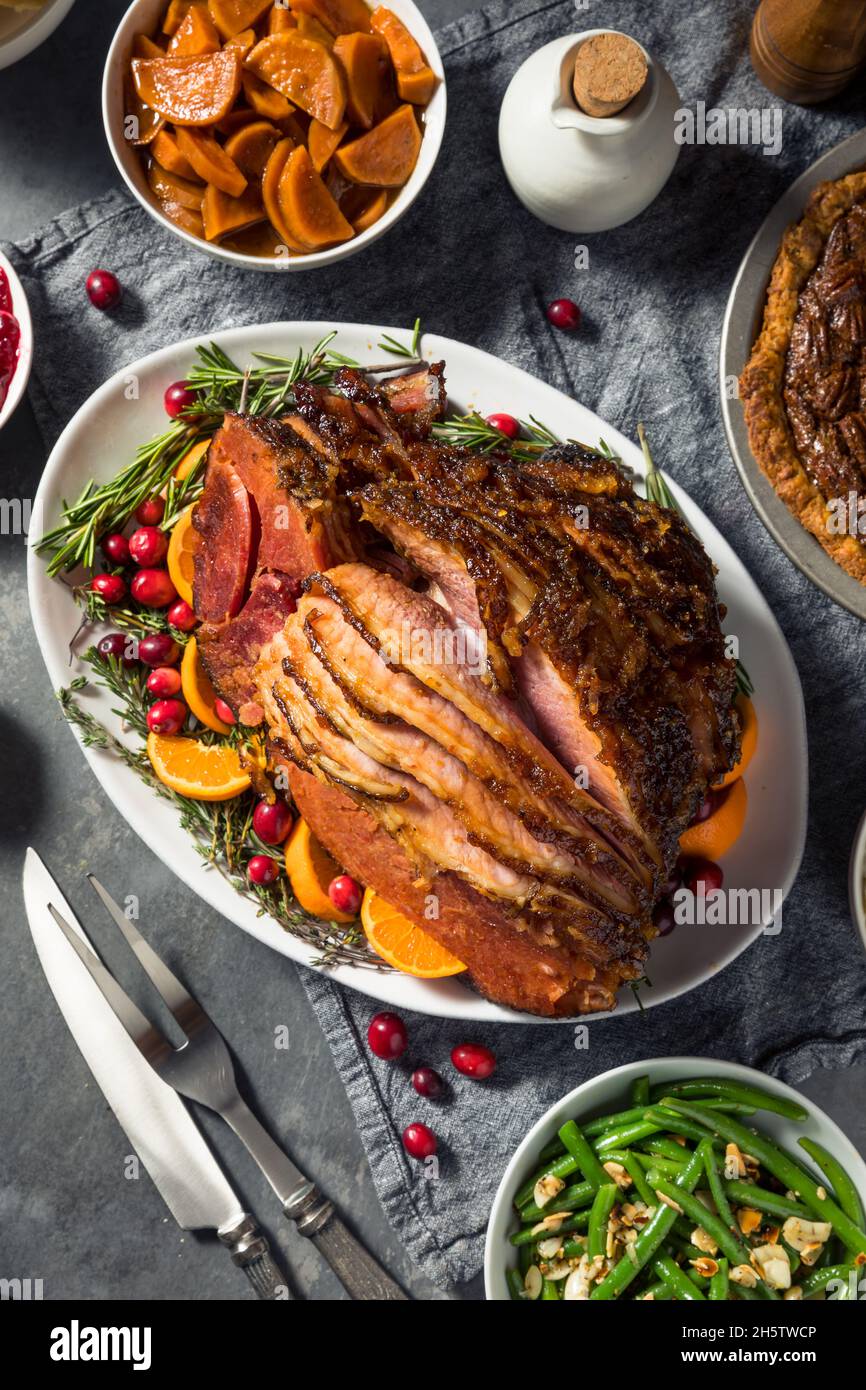 Homemade Christmas Ham Dinner with Potatoes Cranberry and Pecan Pie Stock Photo