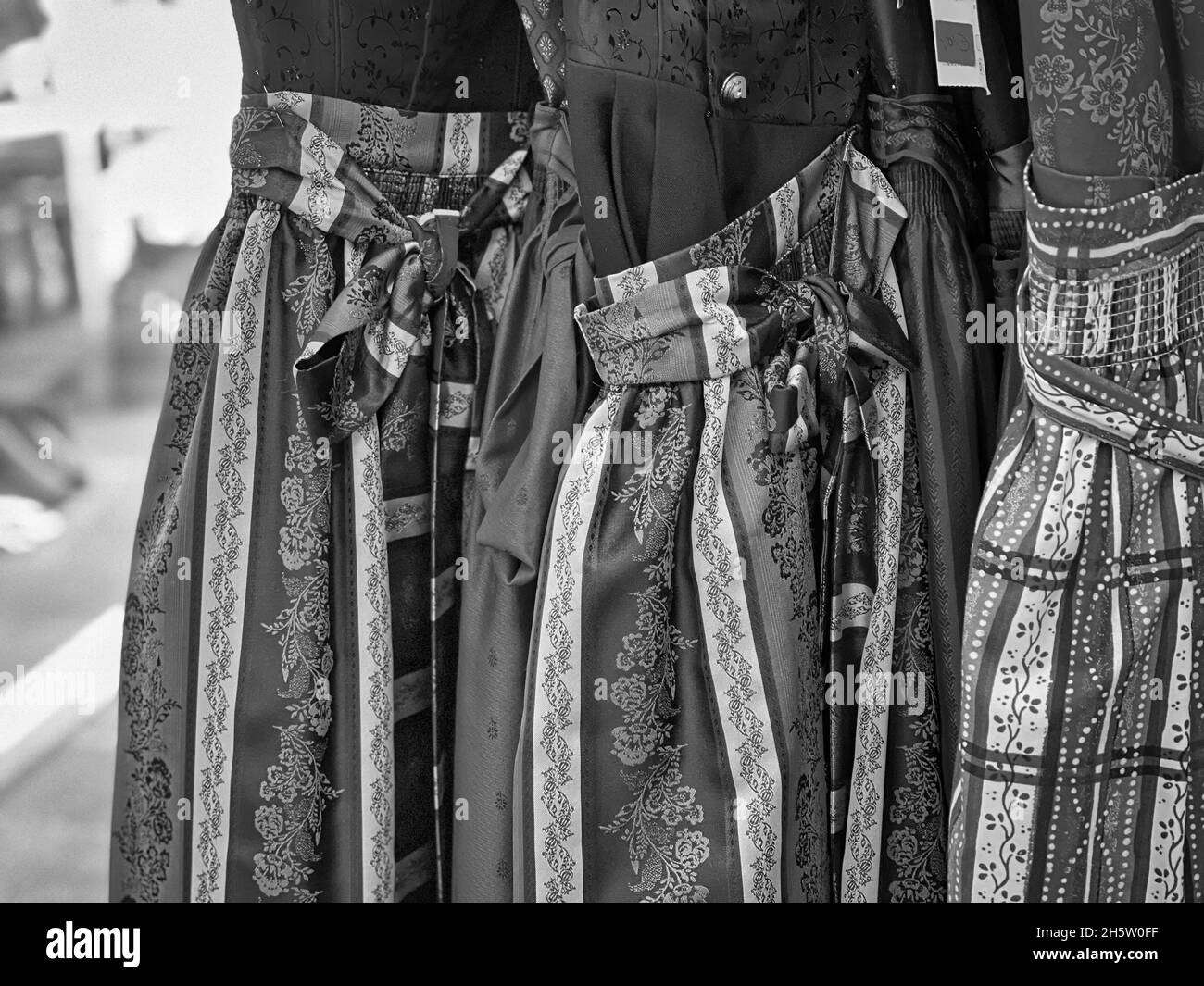 Grayscale shot of dresses with decors for women on display Stock Photo