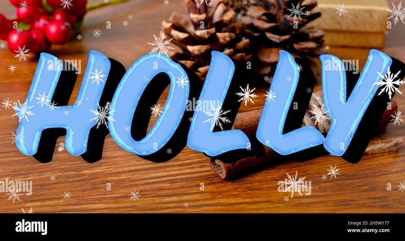 Image of holly text over snow falling and christmas decorations on ...