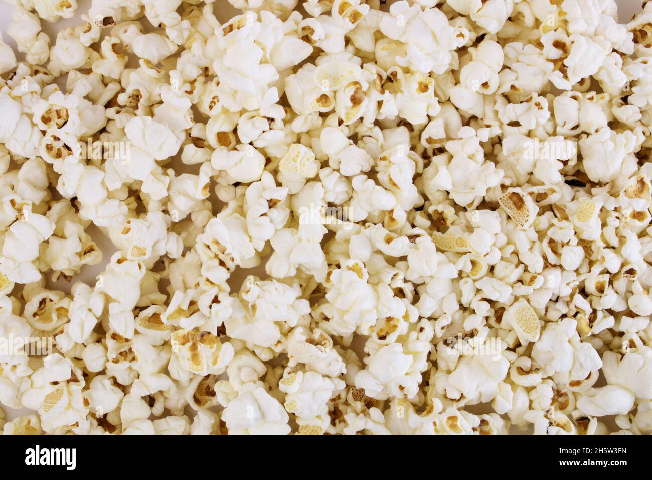 Fresh popcorn background. Popcorn texture. Corn snacks close up Stock