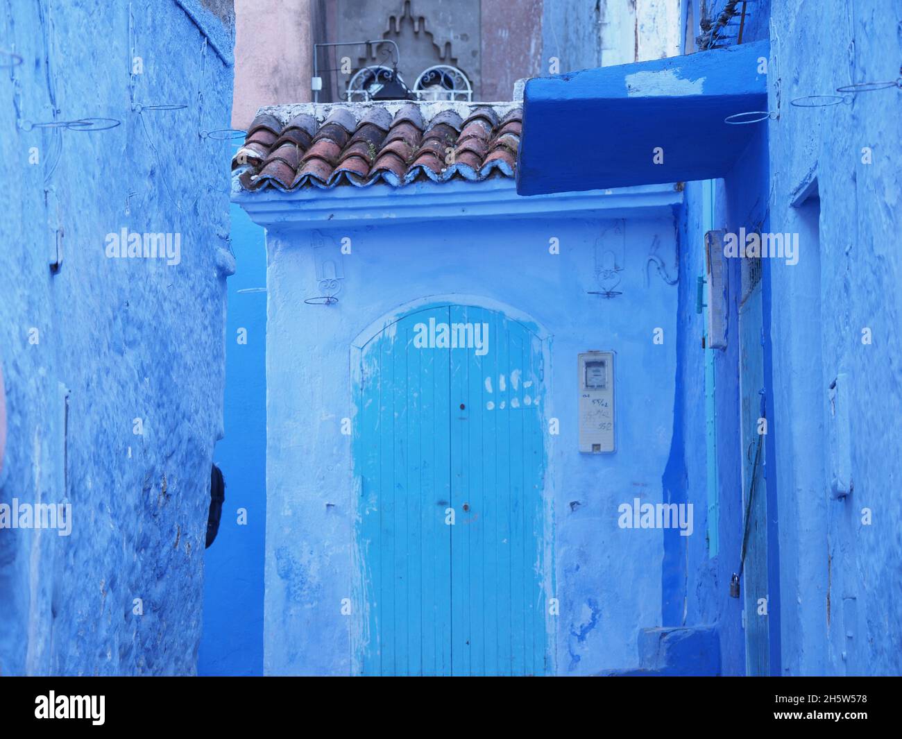 Blue door at moroccan alley in african Chefchaouen city in Morocco in 2019 warm sunny spring day on April. Stock Photo