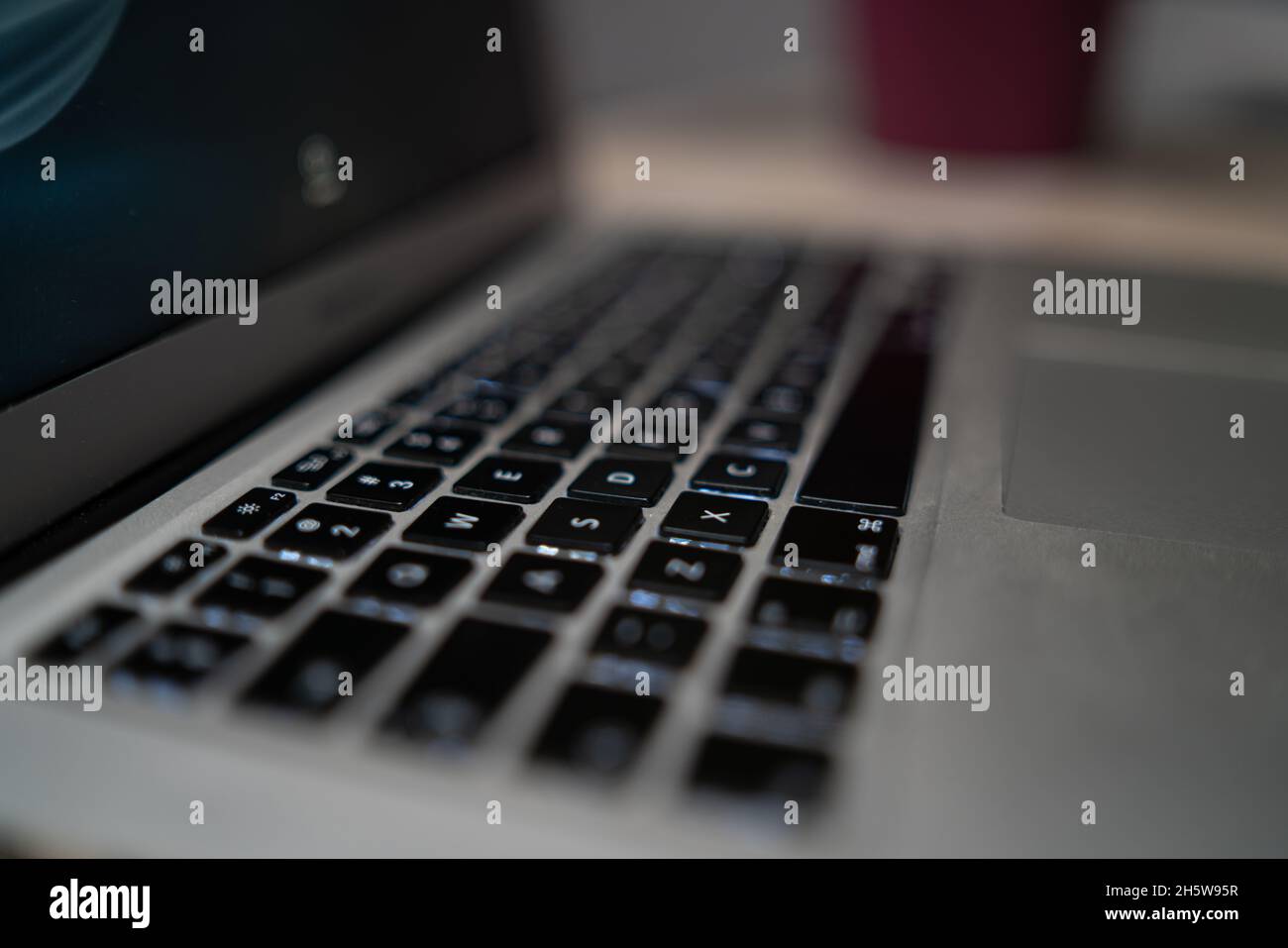 Perspective of the keyboard of a laptop in black and white blur. Selective focus. Stock Photo