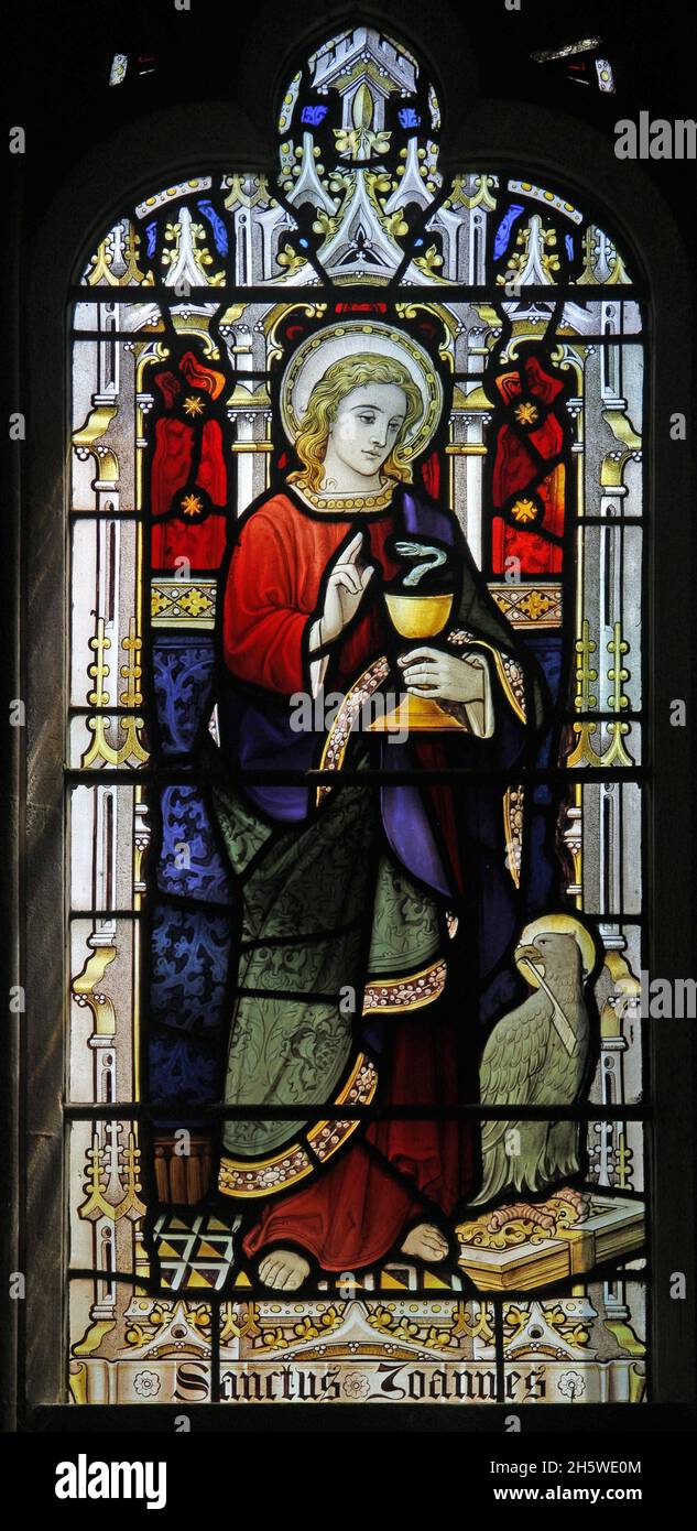 A stained glass window by Lavers Barraud & Westlake of 1908 depicting St John, Church of the Holy Cross, Burley-on-the-Hill, Rutland Stock Photo