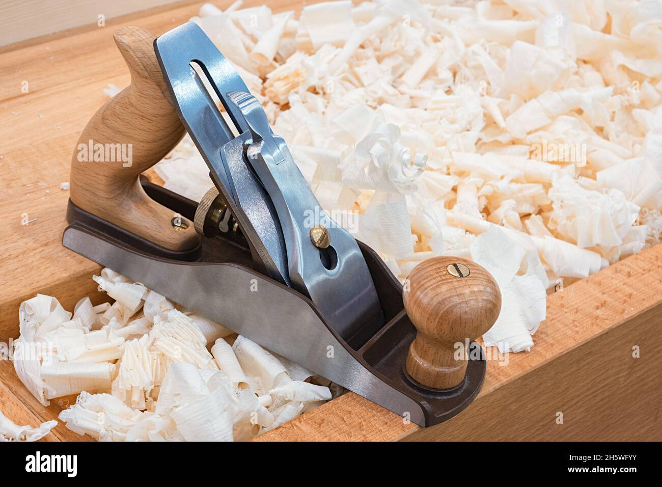 Wooden hand plane for woodworking with wood shavings Stock Photo Alamy