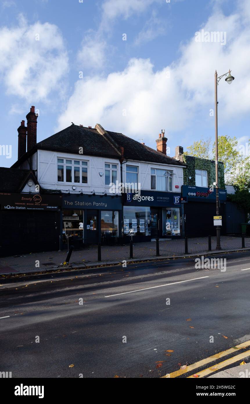 The shops and apartments along station road in Upminster, London, UK