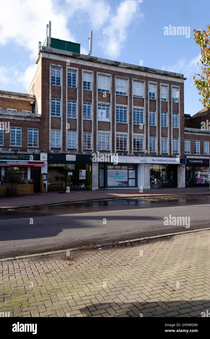 The shops and apartments along station road in Upminster, London, UK