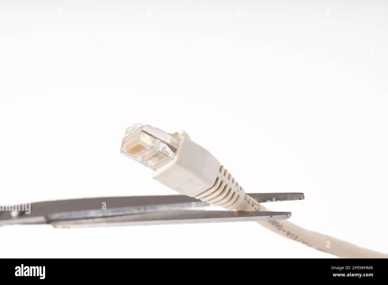 Closeup shot of scissors cutting off internet connection - no internet concept Stock Photo
