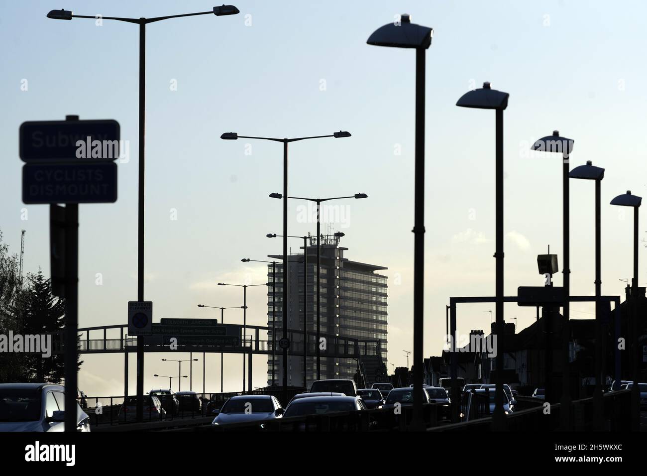Heavy Traffic on the A3 Bypass with Tolworth Tower silhouetted at Sunset  with early evening traffic. Stock Photo