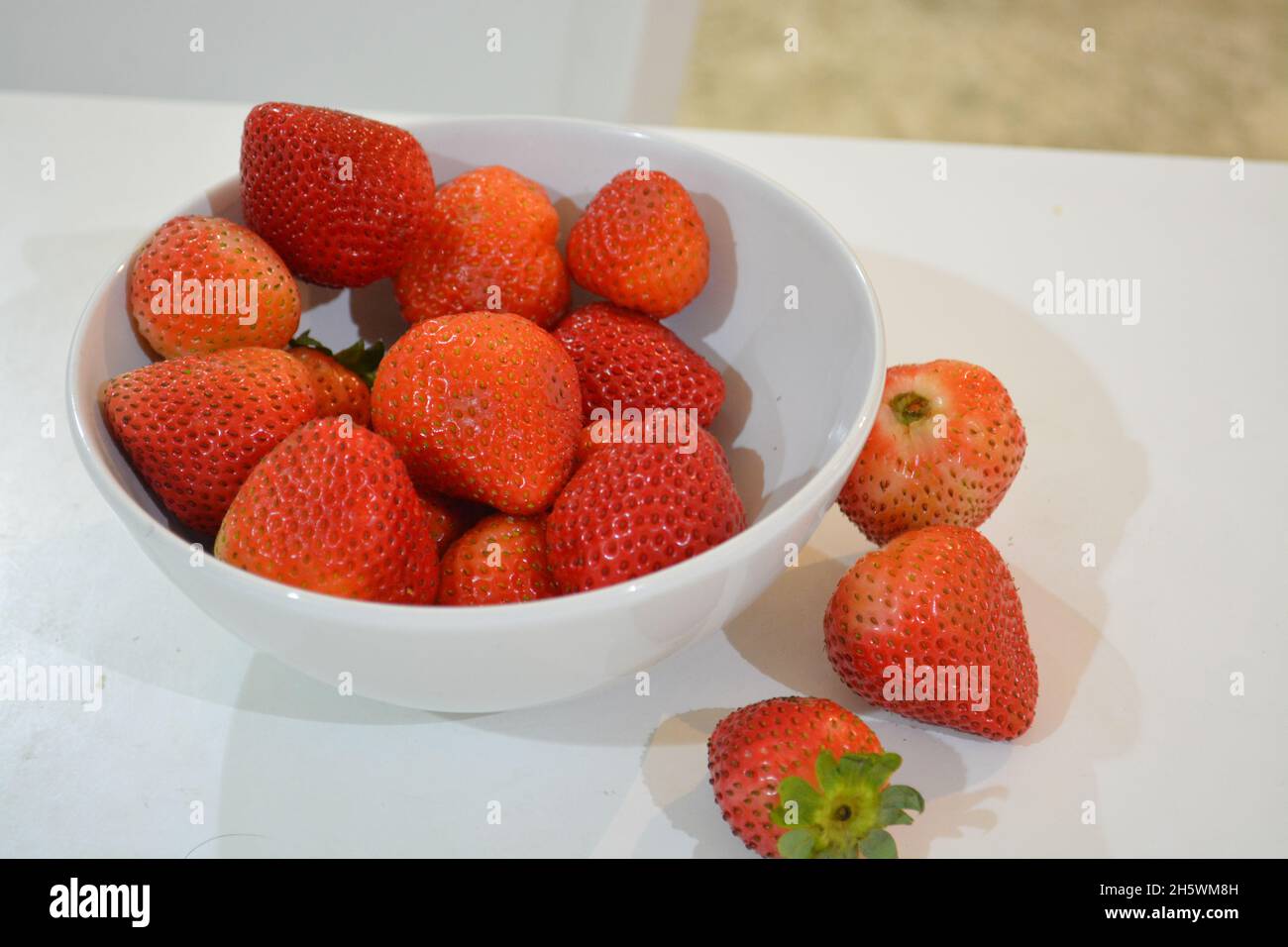 Strawberry in white bowls. Vitamin C Stock Photo