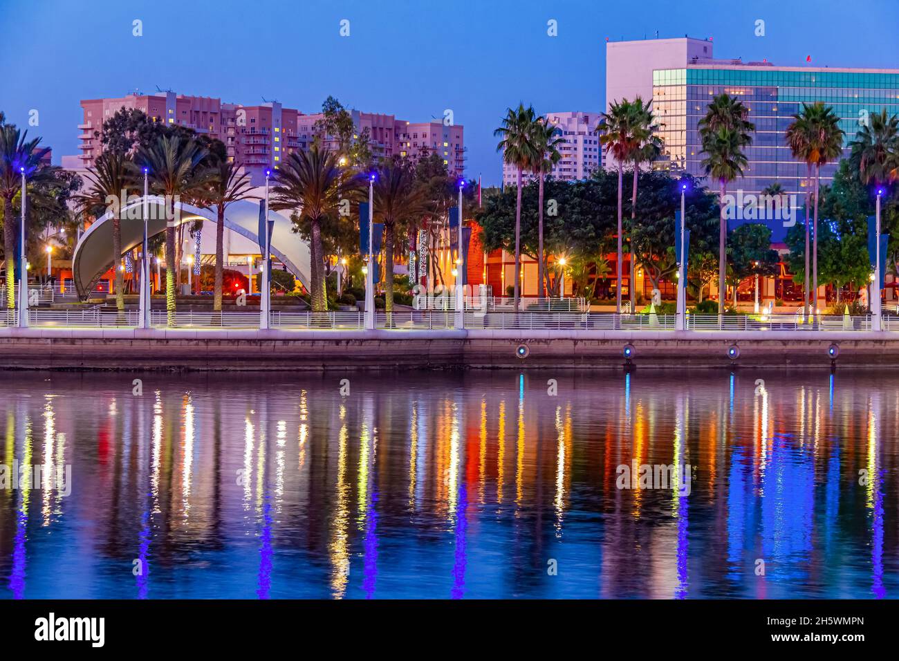 The Long Beach, California skyline is reflected in the still water and the evening light creates a beautiful glow. Stock Photo