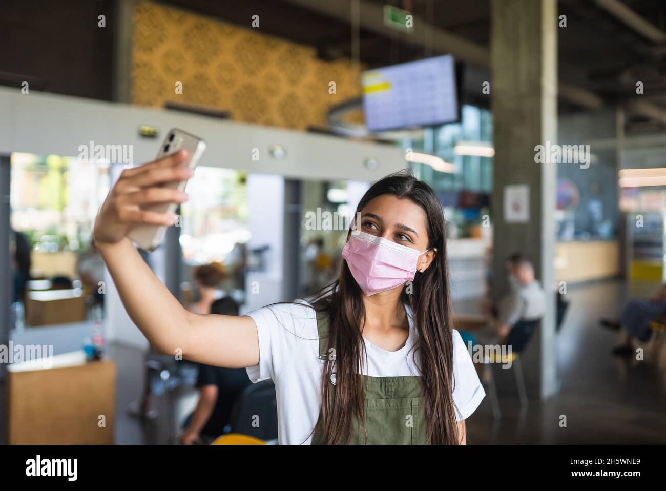 Young woman wearing mask uses hi-res stock photography and images - Alamy