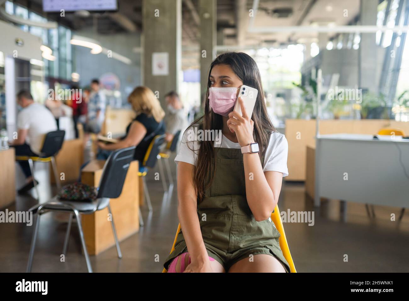 Young woman wearing mask uses hi-res stock photography and images - Alamy