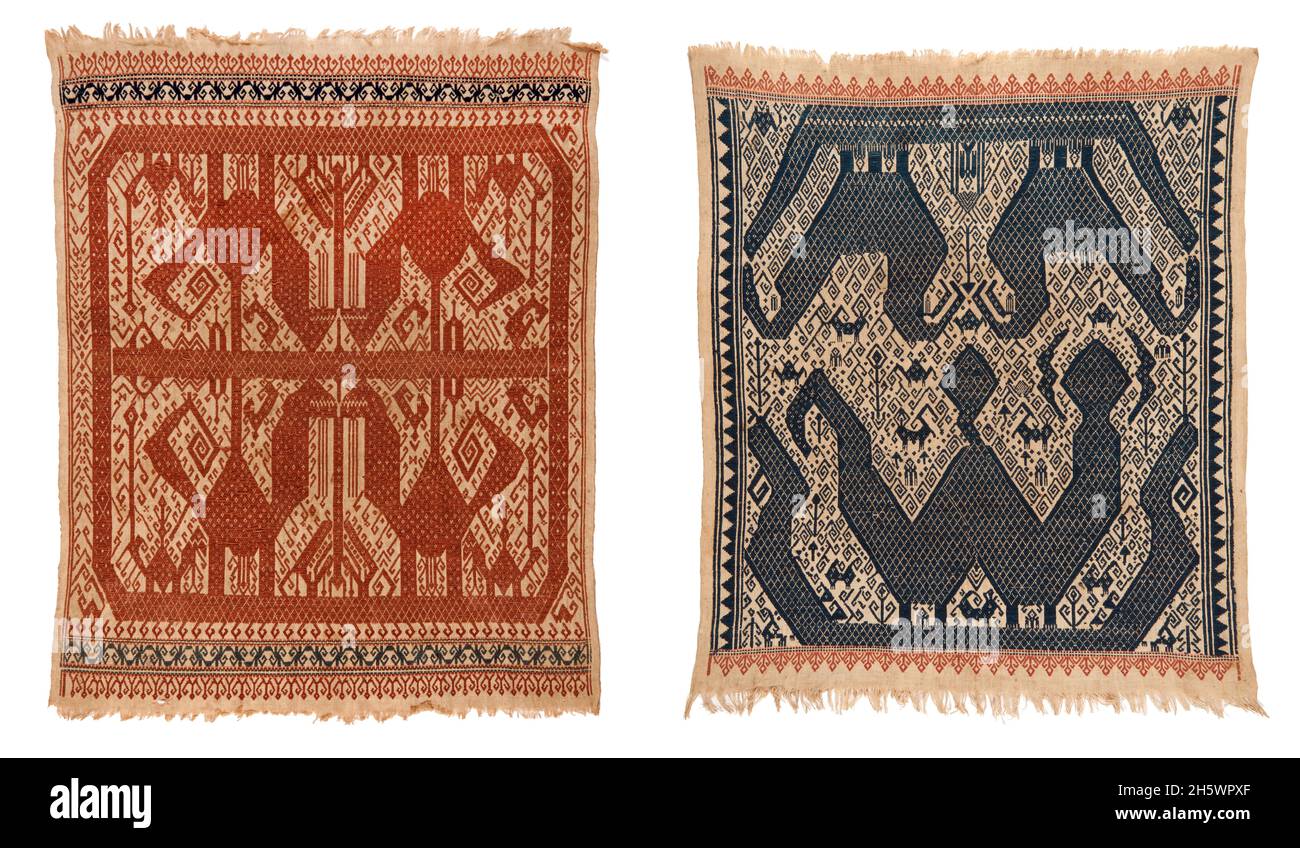 Pair of ceremonial 'shipcloth' textiles, C19th, Lampung, Sumatra. Tampan were used for rites of passage ceremonies, as the focal point for ritual meals, the seat for elders overseeing traditional law, and tied to newly-built houses. Those woven in blue depict the secular realm; in red, the sacred. Examples from the mountainous interior show stylised natural or domestic subjects and geometric designs, while those from the coast (tampan pasisir) display richly detailed scenes of ships and other motifs. The ship, the main motif, symbolises movement, appropriate to the rites of passage rituals. Stock Photo