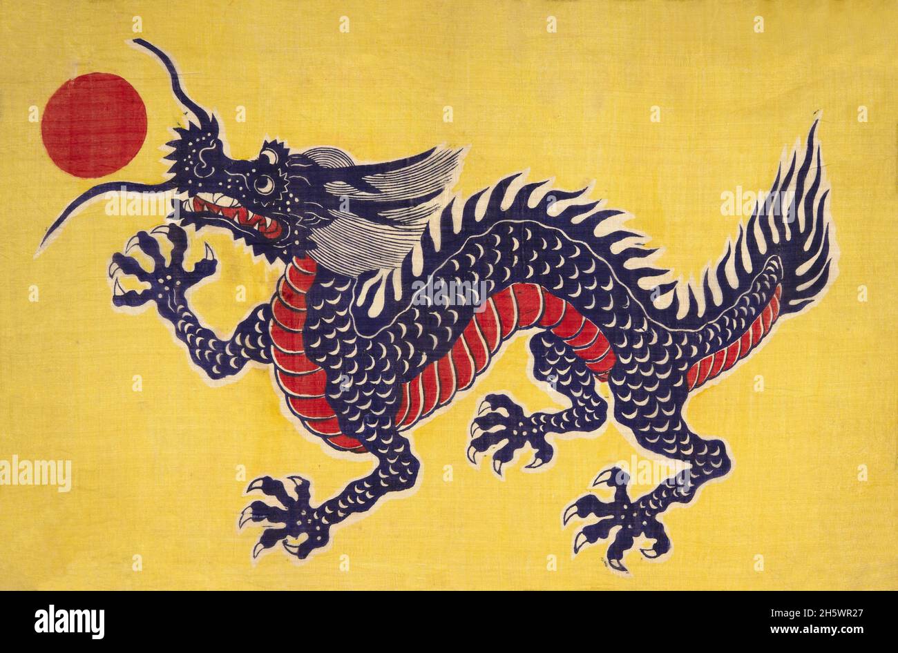 Silk flag depicting a dragon . Emblem of the Chinese Empire during the Ch'ing Dynasty. Yellow-printed silk with five-clawed imperial dragon depicted in purplish blue. Belly scales are red. This type of flag was in use from 1889-1911. Prior to that, flags were usually rectangular-triangular.? Stock Photo