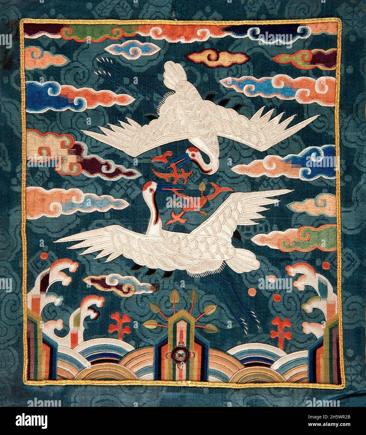 Exquisite Chinese embroidered fabric depicting two cranes É Insignia for officials and officers. These insignia are worn in pairs and may depict a variety of figures, with the motifs by rank having been modified several times throughout history. The double crane indicates the higher rank of the officer and is relatively recent (after 1871). Stock Photo