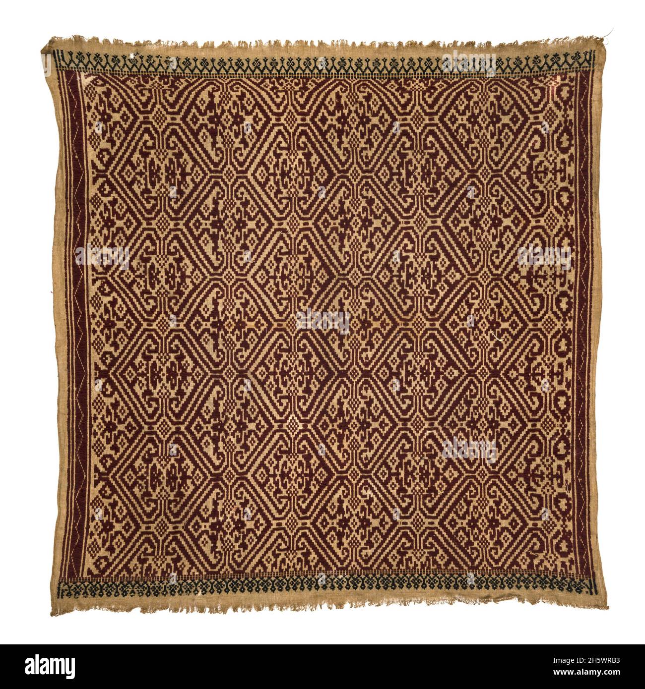 Ceremonial textile, C19th, Lampung, Sumatra. Tampan were used for rites of passage ceremonies, as the focal point for ritual meals, the seat for elders overseeing traditional law, and tied to newly-built houses. Examples from the mountainous interior show stylised natural or domestic subjects and geometric designs, while those from the coast (tampan pasisir) display richly detailed scenes of ships and other motifs. The ship, the main motif, symbolises movement, appropriate to the rites of passage rituals. Stock Photo