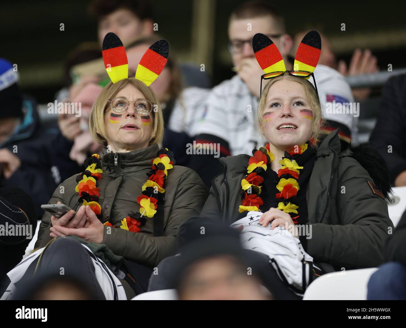 Wolfsburg, Germany. 11th Nov, 2021. Football: National Team, World Cup Qualification, Group Stage, Group J, Matchday 9, Germany - Liechtenstein at Volkswagen Arena. Two women have put on 'German' rabbit ears. Credit: Christian Charisius/dpa/Alamy Live News Stock Photo