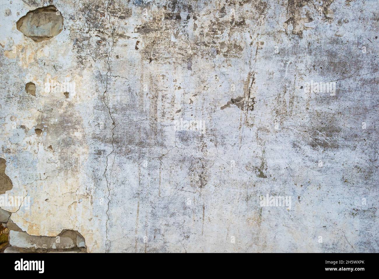 Cracked concrete wall texture or background. Closeup Stock Photo