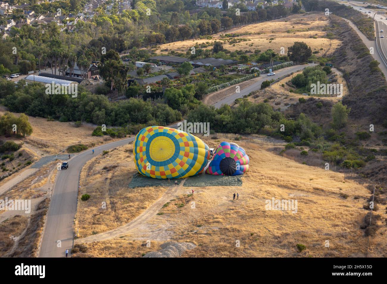 Aerial view of colorful hot air balloons preparation for launch over