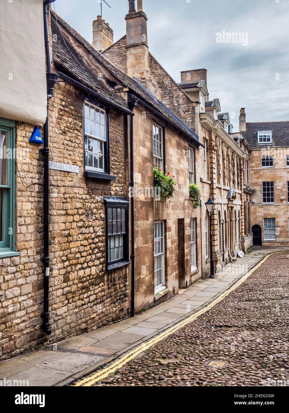 Colourful street scene in the Lincolnshire town of Stamford famous for its narrow street with buff stone buildings and Georgian architecture Stock Photo