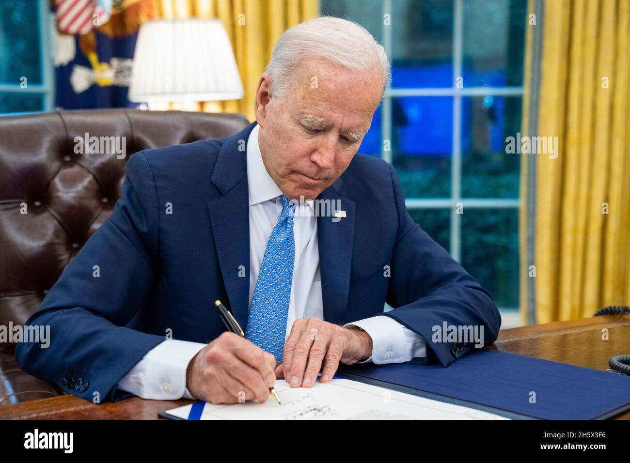 Washington, United States. 31 August, 2021. U.S. President Joe Biden signs the Emergency Reparation Assistance for Returning Americans Act, in the Oval Office of the White House August 31, 2021 in Washington, D.C. Credit: Adam Schultz/White House Photo/Alamy Live News Stock Photo